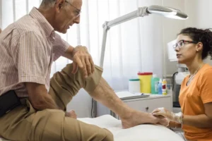 Physician evaluating heel pain during podiatry exam for possible plantar fasciitis.