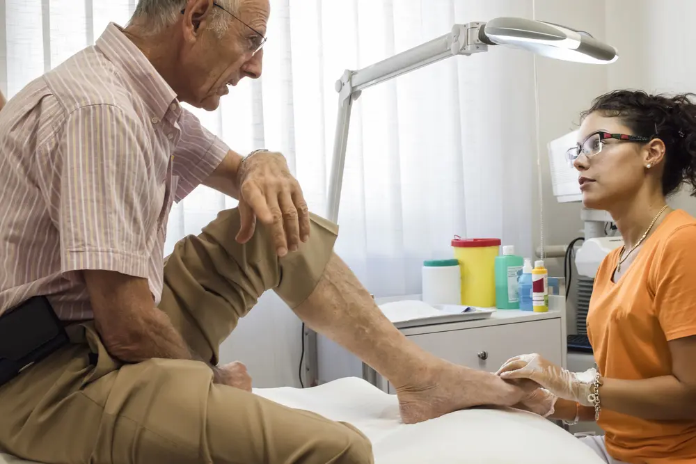 Physician evaluating heel pain during podiatry exam for possible plantar fasciitis.